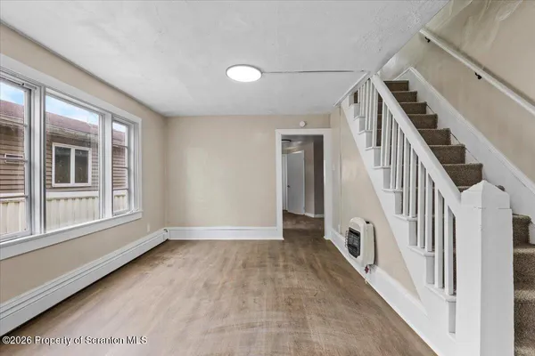 wooden floor in an empty room with a window