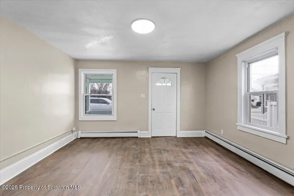 an empty room with windows and closet