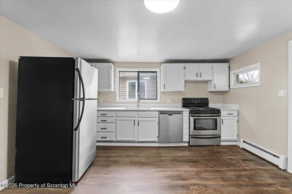 a kitchen with cabinets and stainless steel appliances