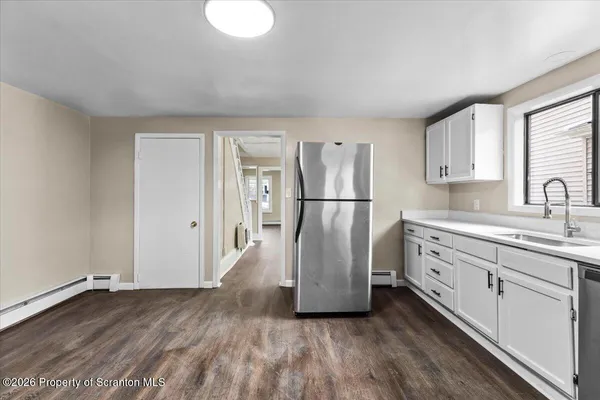 a view of a kitchen with a refrigerator in it