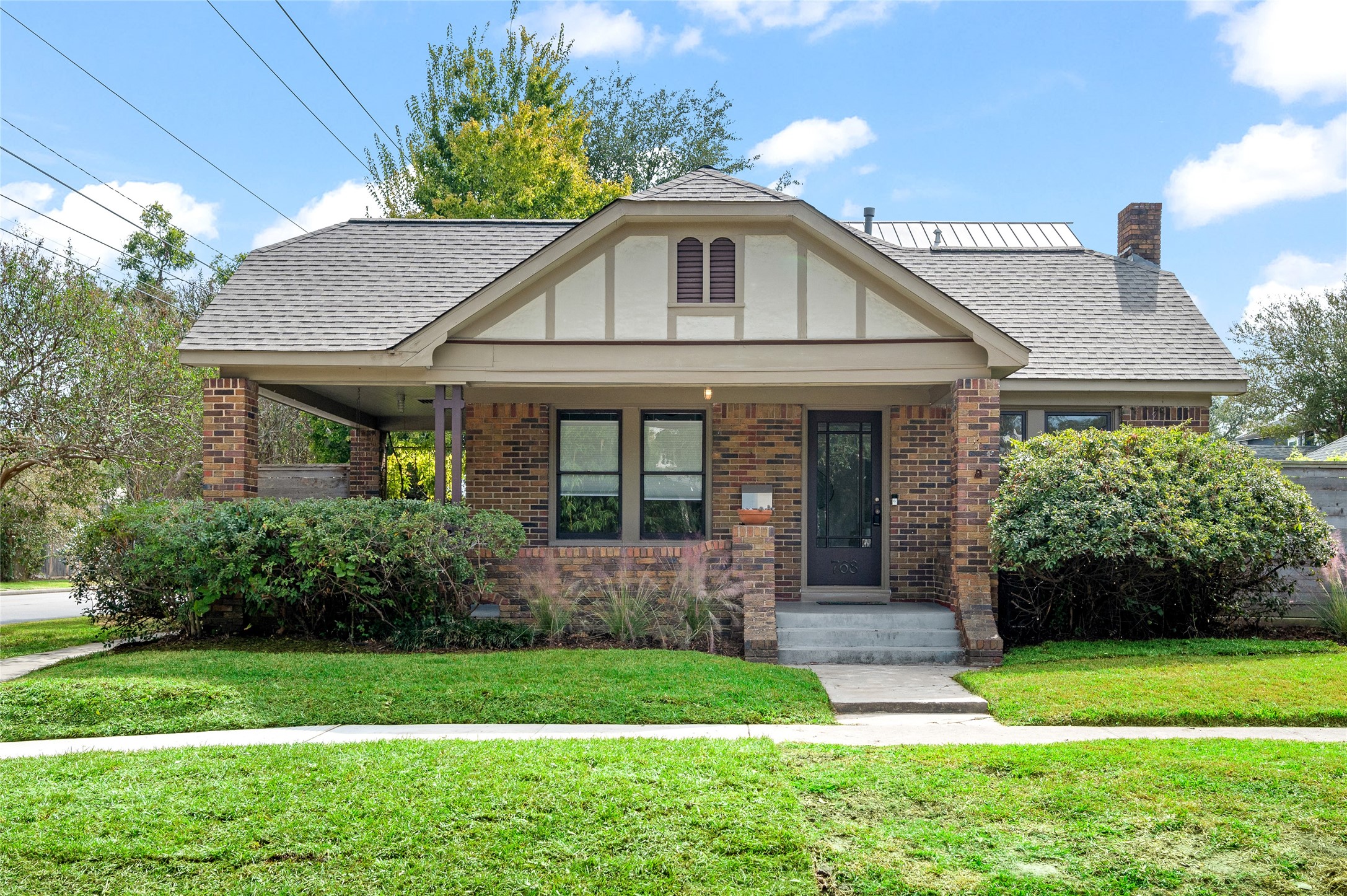 768 East 16th Street Houston, TX 77008 - Photo 2 of 49 Nestled on a corner lot, this 1930's bungalow marries classic architecture with artful modern design.