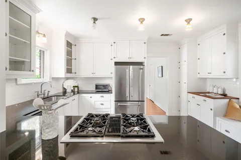 a kitchen with stainless steel appliances granite countertop a stove and a refrigerator