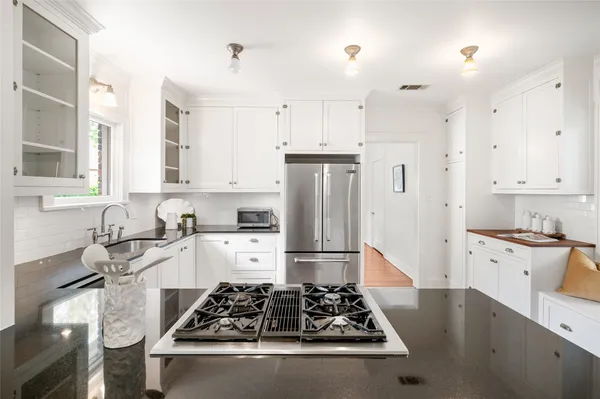 a kitchen with stainless steel appliances granite countertop a stove and a refrigerator