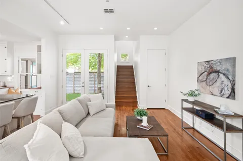 a living room with furniture and wooden floor