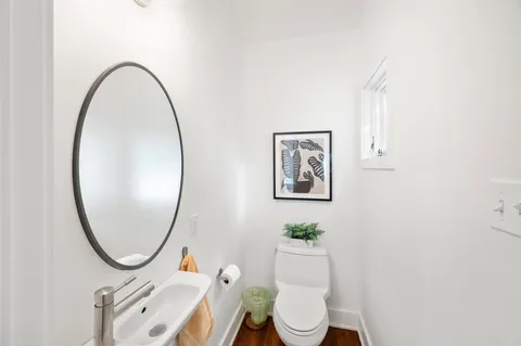 a bathroom with a toilet a sink and a mirror