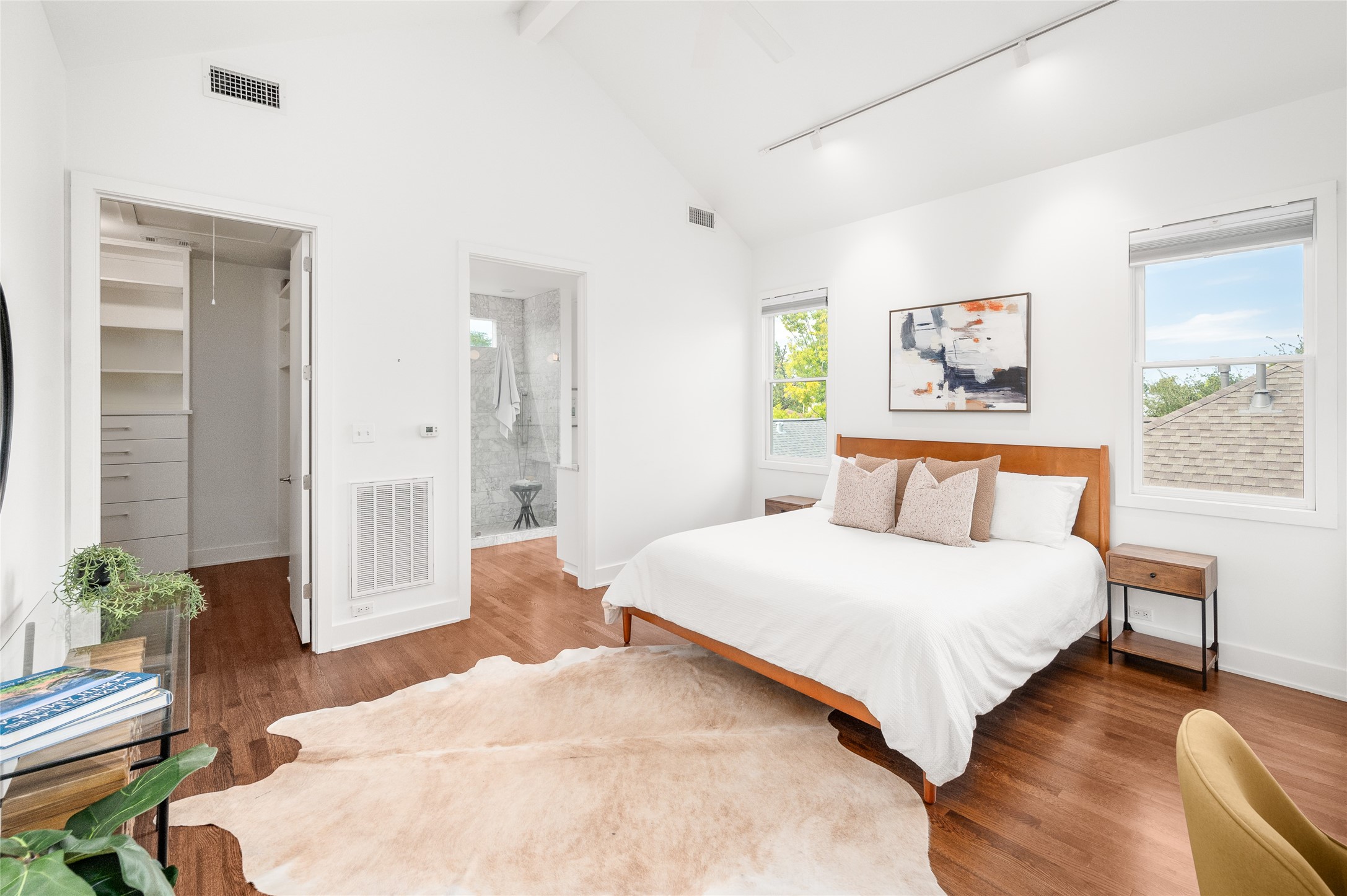 768 East 16th Street Houston, TX 77008 - Photo 35 of 49 Primary suite has it all! A walk in closet, an en suite bath, natural light, soaring ceilings, a balcony, and all the modern comfort.