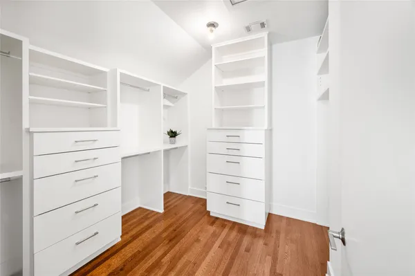 a view of walk in closet with clothes
