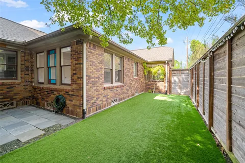 a view of house with backyard