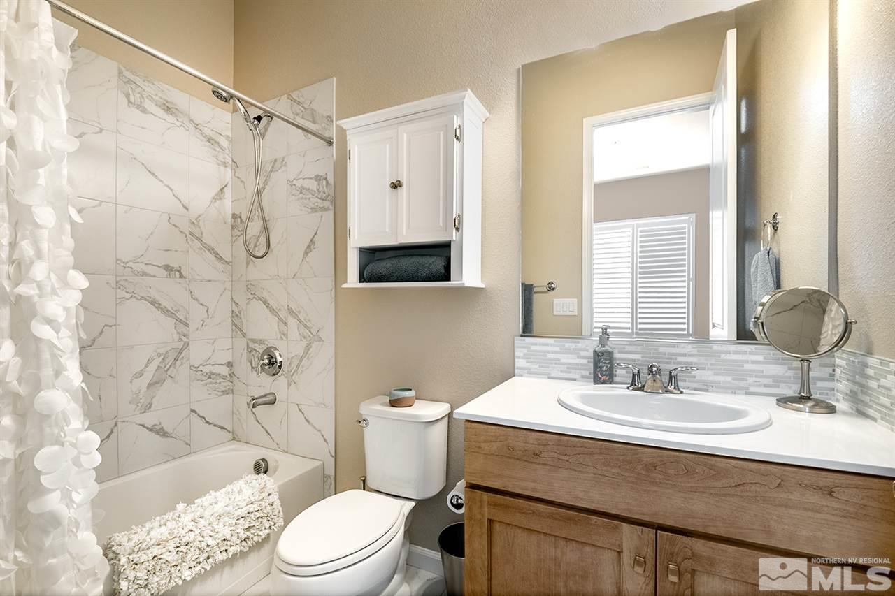 9815 Shadowless Trail Reno, NV 89521 - Photo 18 of 25 a bathroom with a sink toilet vanity and shower