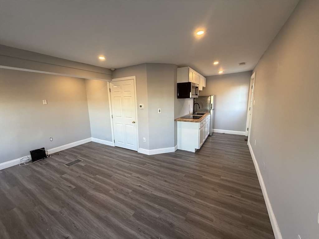 176 Court Street, Unit 1 Plymouth, MA 02360 - Photo 3 of 11 a view of empty room with wooden floor