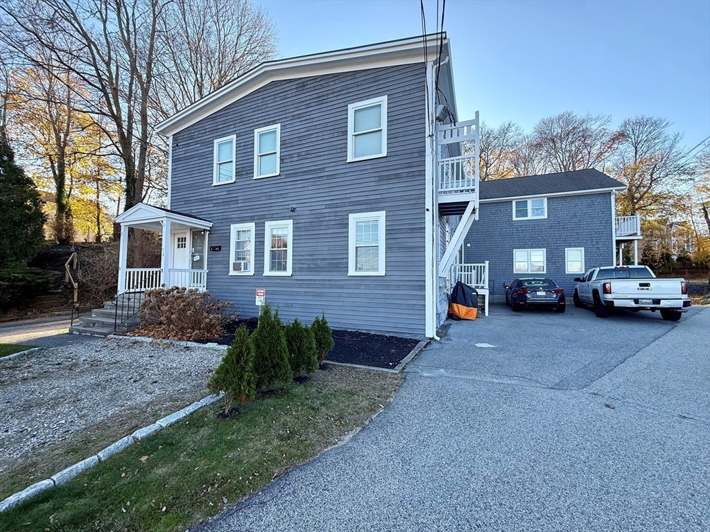 176 Court Street, Unit 1 Plymouth, MA 02360 - Photo 9 of 11 a view of a car parked in front of a brick house
