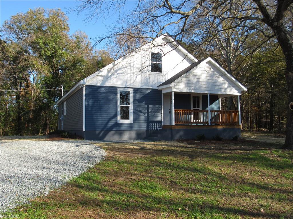 4060 Sowers Road Linwood, NC 27299 - Photo 1 of 28 Front view of the house with a covered front porch.