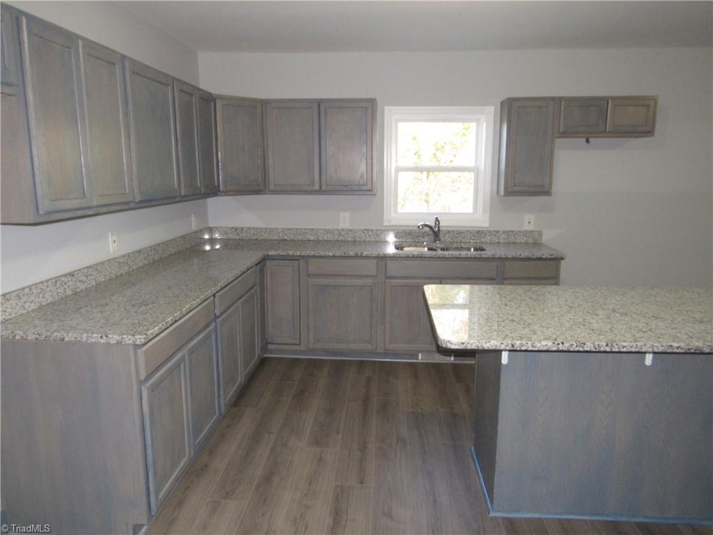 4060 Sowers Road Linwood, NC 27299 - Photo 12 of 28 Another view of the kitchen with laminate flooring