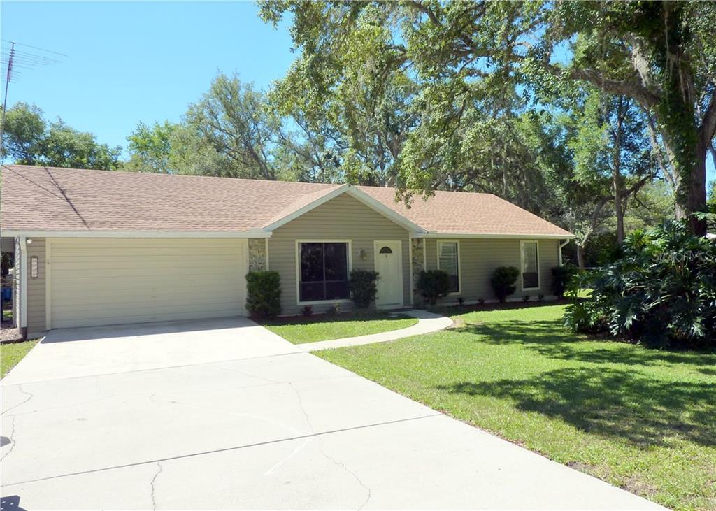 4489 Daugharty Road DeLand, FL 32724 - Photo 1 of 1 a front view of a house with a yard and garage