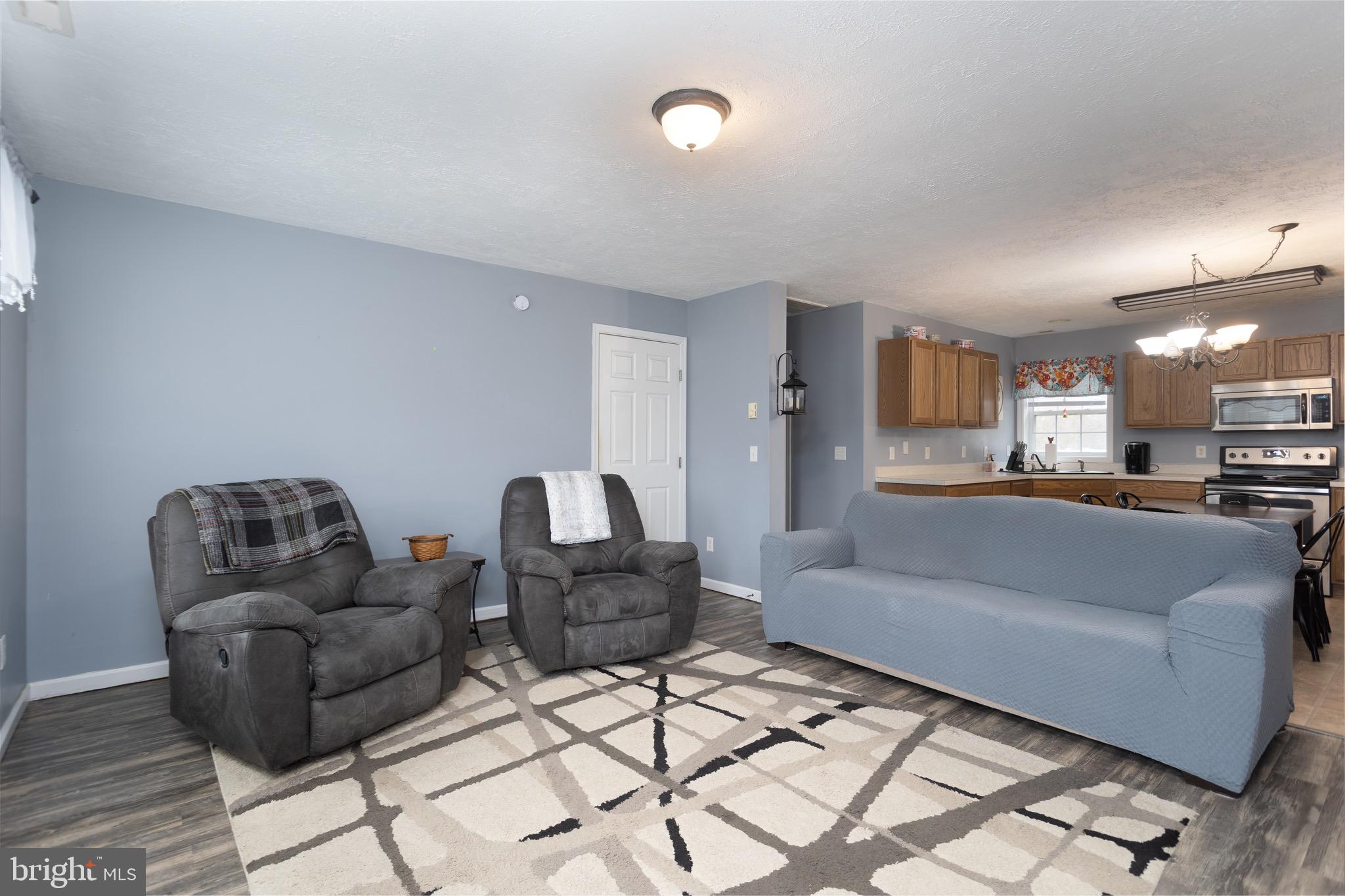 1303 Colonial Avenue Cambridge, MD 21613 - Photo 2 of 12 a living room with furniture and a view of kitchen