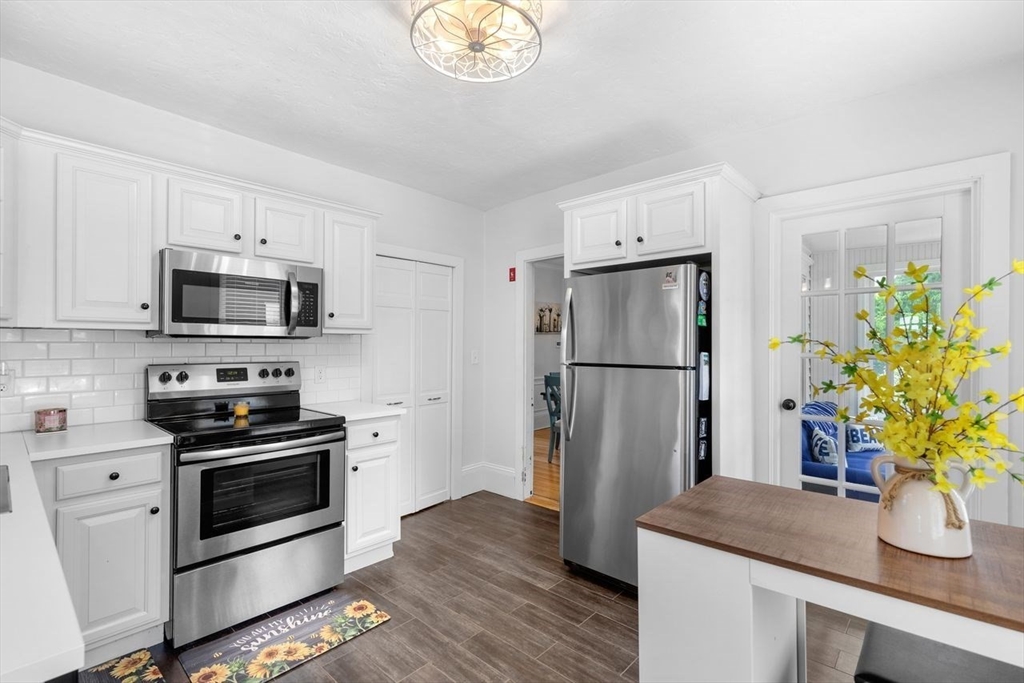 1012 Washington Street Whitman, MA 02382 - Photo 5 of 37 a kitchen with stainless steel appliances a refrigerator a stove a microwave and cabinets