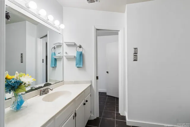 a bathroom with a sink and a mirror