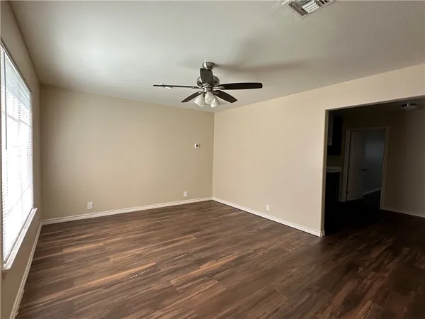 wooden floor in an empty room with a window