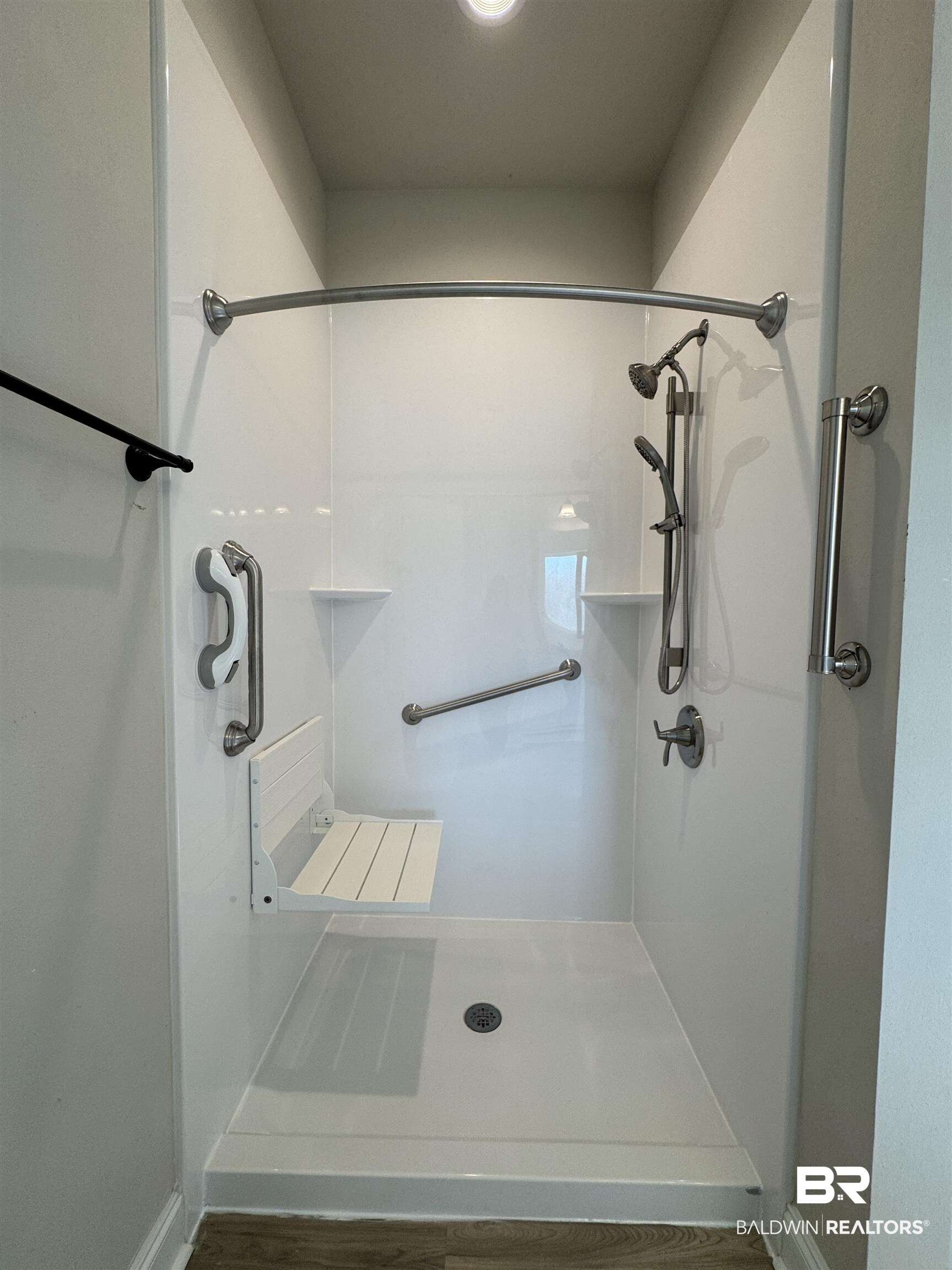 1060 Chloe Street Foley, AL 36535 - Photo 9 of 28 Walk-in shower with a built-in folding seat, dual showerheads, and multiple grab bars