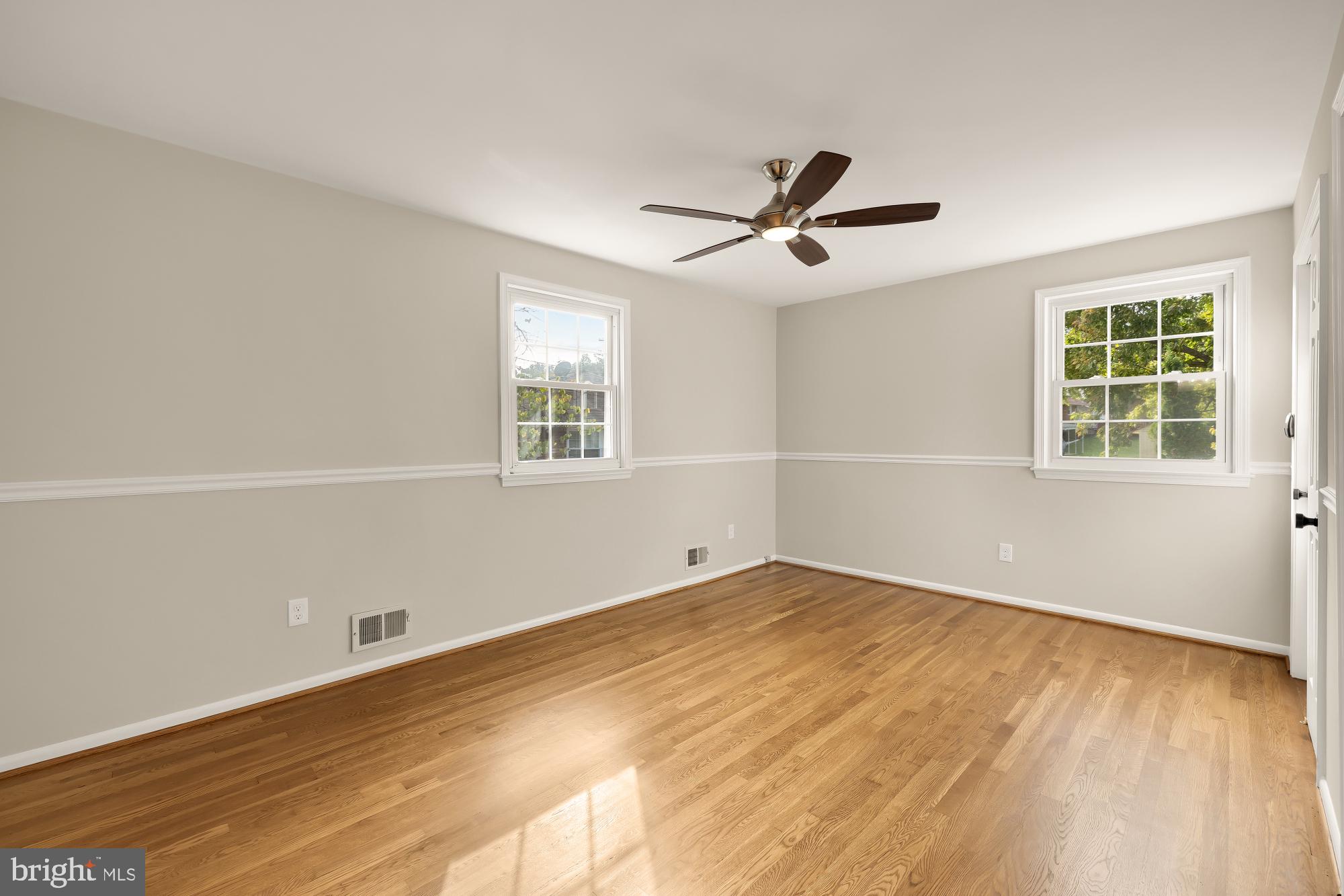3173 Castleleigh Road Silver Spring, MD 20904 - Photo 36 of 56 a view of empty room with wooden floor and fan
