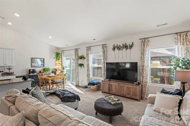 a bathroom with a granite countertop sink a toilet and a mirror