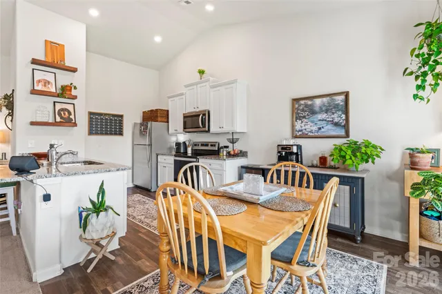 a bedroom with a bed a couch and a flat tv screen on dresser
