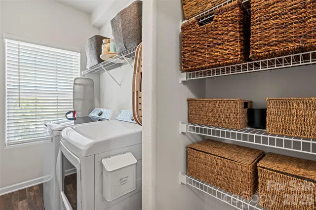 a bedroom with a bed a flat screen tv and a chandelier