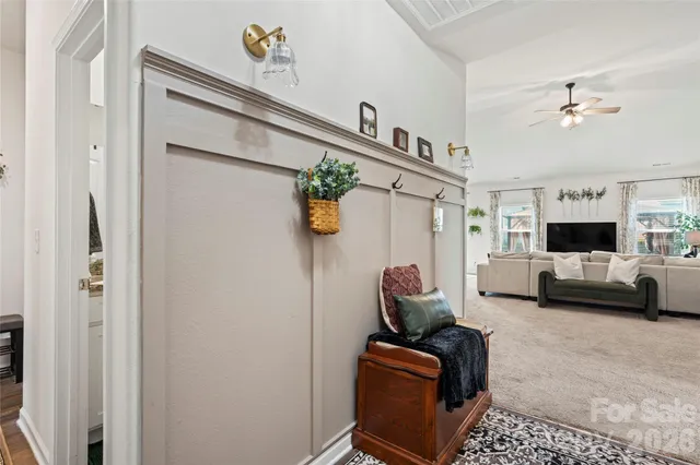 a living room with furniture a couch and a window