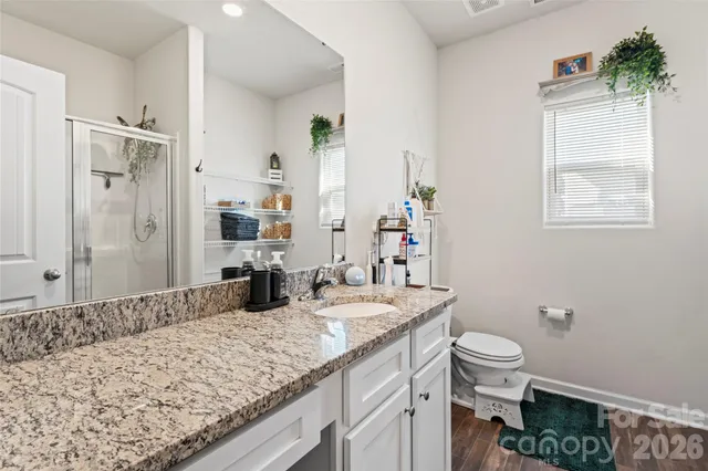 a view of a patio with table and chairs potted plants with wooden fence
