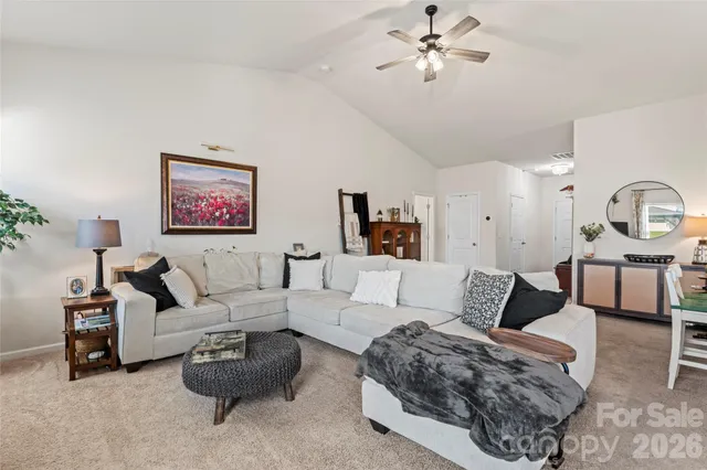 a living room with furniture ceiling fan and a rug