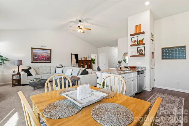 a living room with furniture and kitchen view