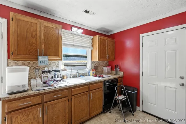 a kitchen with a sink cabinets and a window
