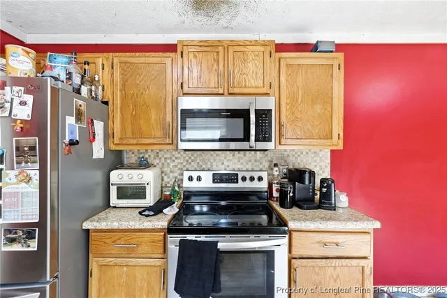 a kitchen with a stove and a microwave