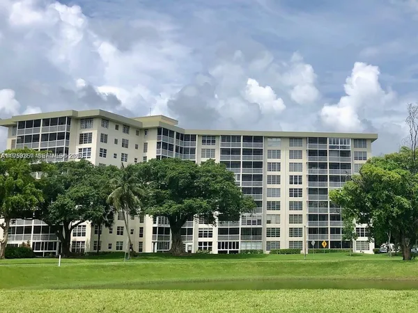 a front view of a building with a garden