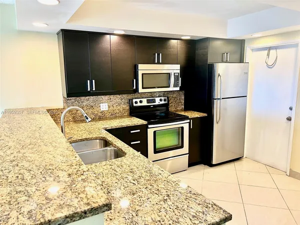 a kitchen with a refrigerator sink and stove
