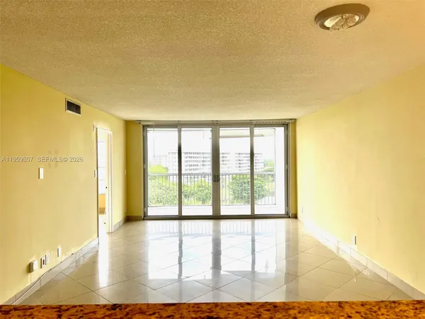 a view of an empty room with glass door