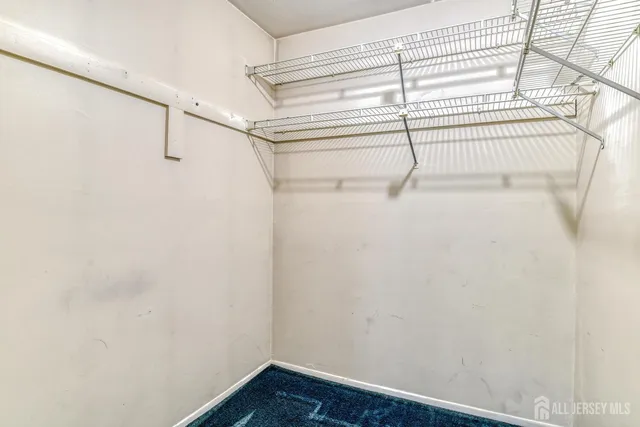 an empty room with fan and windows