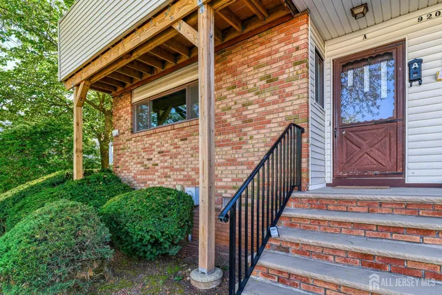 a view of front door of house with stairs