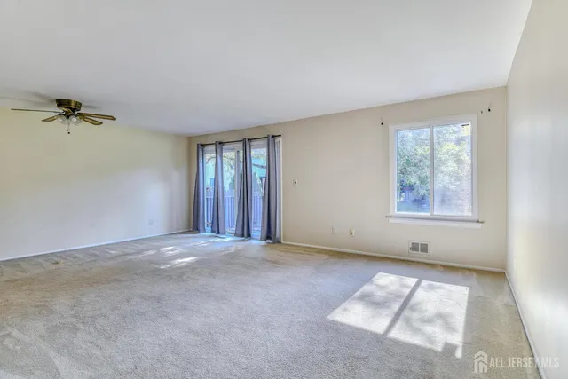 a kitchen with kitchen island white cabinets a refrigerator a stove a sink and a stove