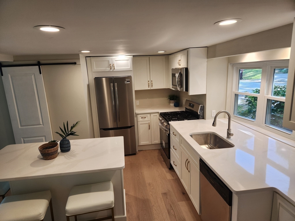 41 Pecksuot Road Weymouth, MA 02191 - Photo 12 of 22 a kitchen with refrigerator and sink