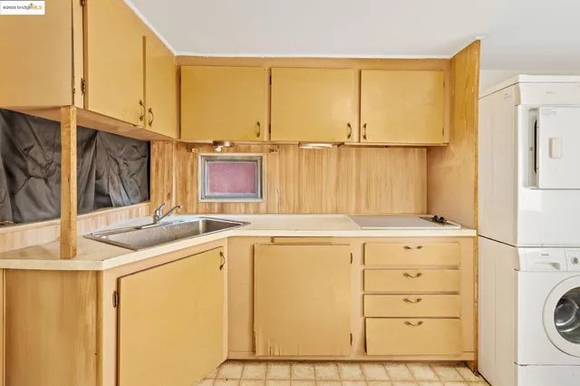 a kitchen with a sink and a refrigerator