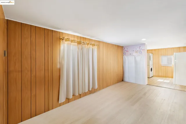 a view of walk in closet with wooden floor