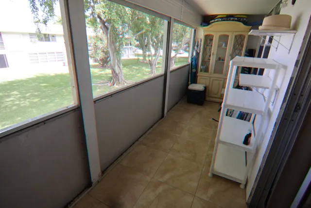 a view of an empty room with a sink and dishwasher