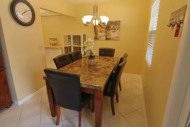 a view of a dining room with furniture and a chandelier
