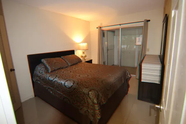 a bedroom with a bed and a mirror