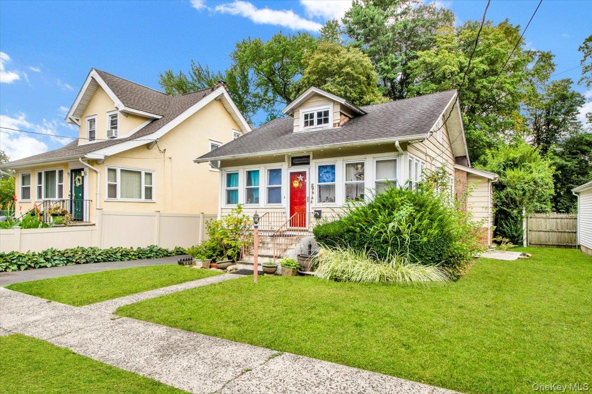 Bungalow-style house featuring roof with shingles