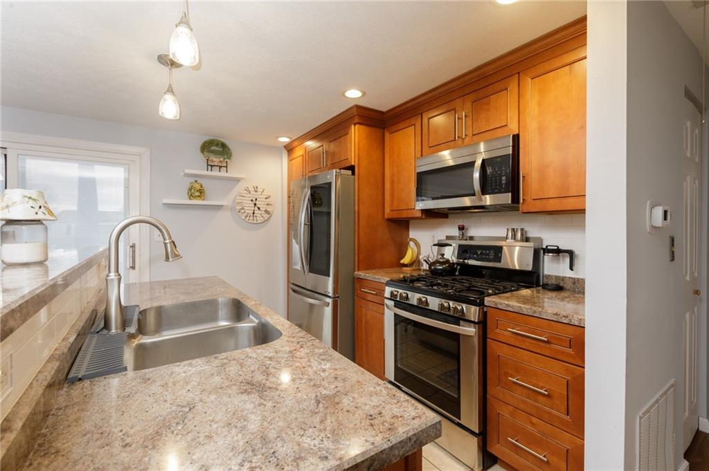 181 Partridge Run Road Gibsonia, PA 15044 - Photo 5 of 34 a kitchen with stainless steel appliances granite countertop a stove a sink and a refrigerator
