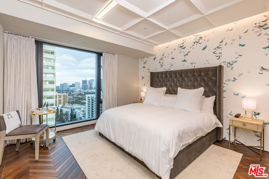 10727 Wilshire Boulevard, Unit 1805 Los Angeles, CA 90024 - Photo 18 of 34 a bedroom with bed and wooden floor