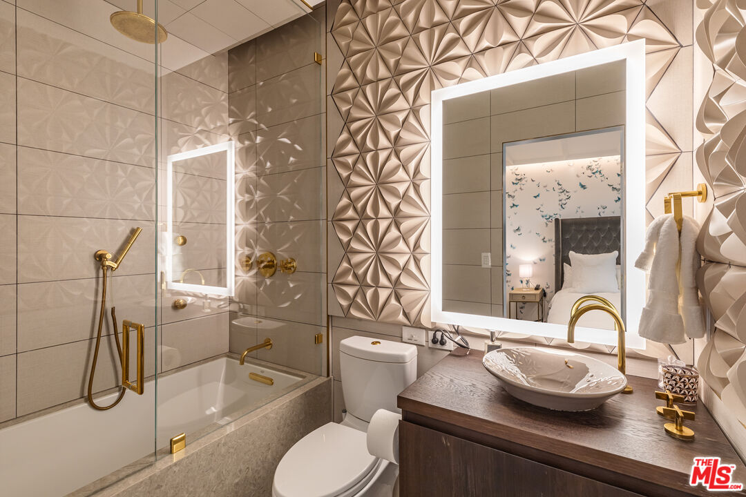 10727 Wilshire Boulevard, Unit 1805 Los Angeles, CA 90024 - Photo 19 of 34 a bathroom with a granite countertop sink and a mirror