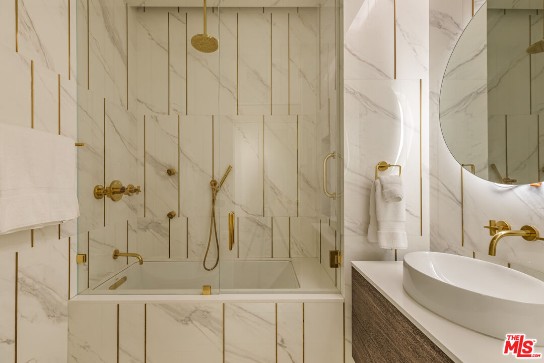 10727 Wilshire Boulevard, Unit 1805 Los Angeles, CA 90024 - Photo 26 of 34 a bathroom with a granite countertop sink a toilet and a mirror
